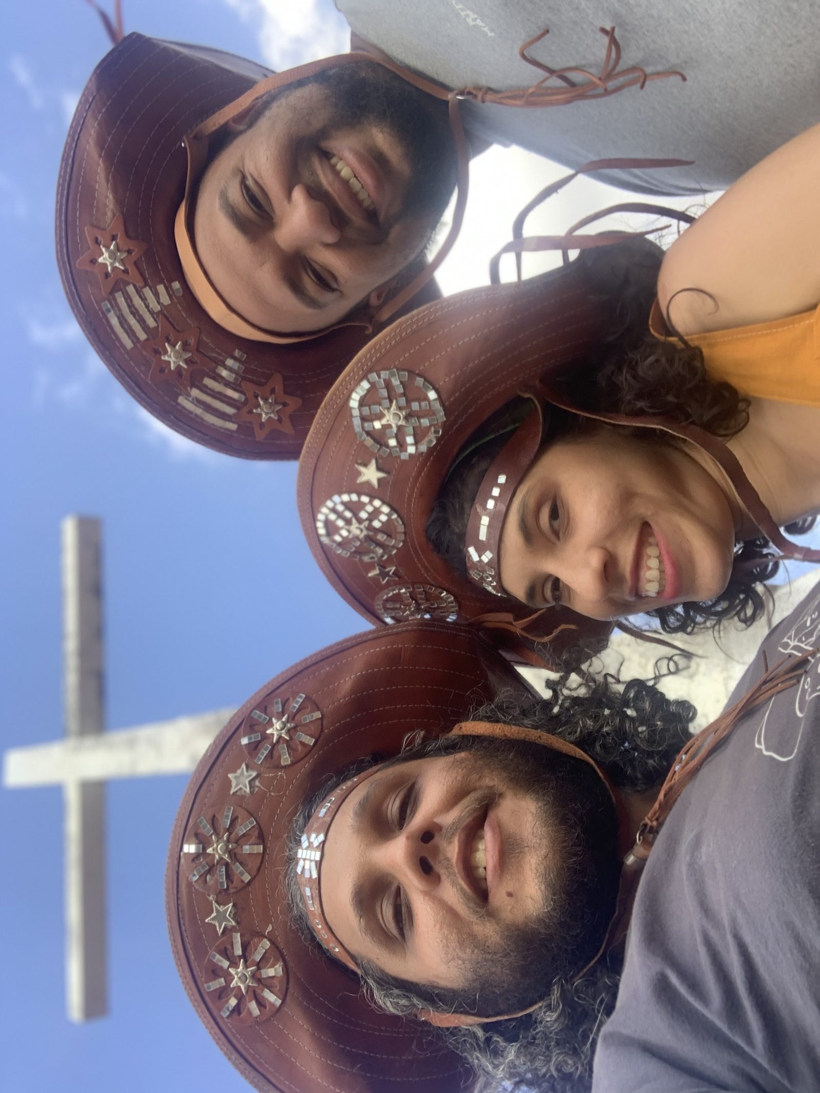 A equipe do Empório de chapéu de couro, sob o cruzeiro da serra